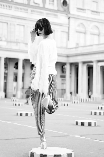 Woman pose on high heel shoes in paris, france. Sensual woman with brunette hair. Beauty girl with glamour look. Fashion model in sunglasses on square. Fashion beauty and vogue - Fotografie, Obrázek