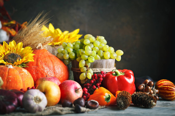 Happy Thanksgiving Day background, wooden table decorated with Pumpkins, Maize, fruits and autumn leaves. Harvest festival. Selective focus. Horizontal. Background with copy space. - Photo, image