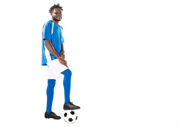 full length view of athletic african american sportsman standing with soccer ball and smiling at camera isolated on white - Fotografie, Obrázek