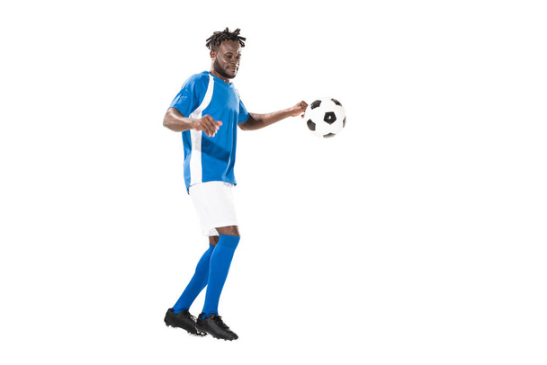 full length view of athletic african american sportsman playing with soccer ball isolated on white  - Φωτογραφία, εικόνα