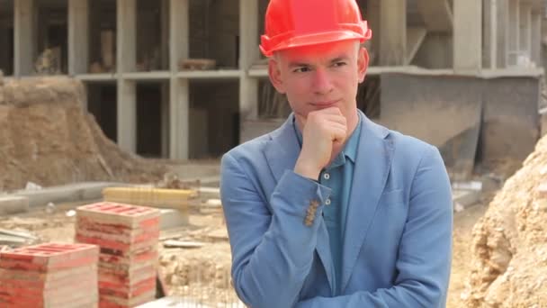 Portrait of a young architect at a construction site. - Filmati, video