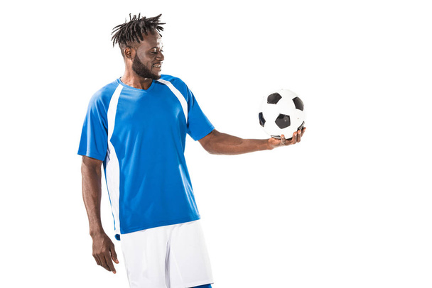 smiling african american sportsman holding soccer ball isolated on white  - Zdjęcie, obraz