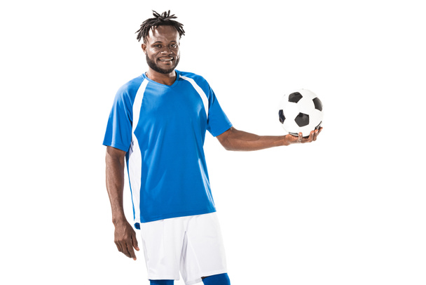 happy african american sportsman holding soccer ball and smiling at camera isolated on white  - Fotografie, Obrázek
