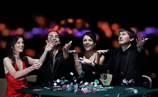 Group of young people playing poker at the gambling house - Foto, Bild