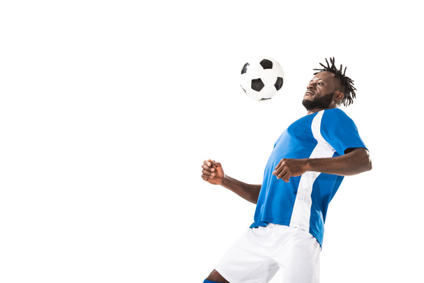 athletic young african american soccer player hitting ball with chest isolated on white   - Φωτογραφία, εικόνα