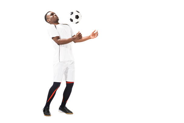 young african american soccer player hitting ball with chest isolated on white   - Valokuva, kuva