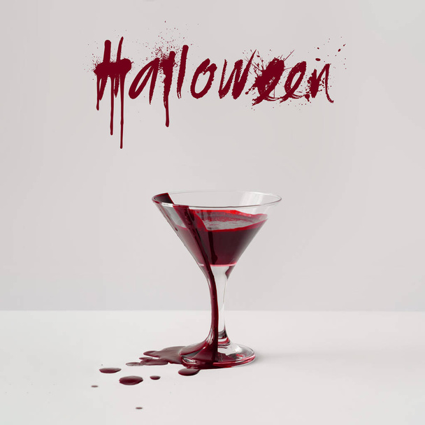 Martini glass full of blood and text Halloween, Minimal horror concept  - Φωτογραφία, εικόνα