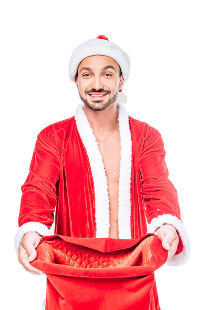 happy young man in santa claus costume with christmas sack isolated on white background - Zdjęcie, obraz