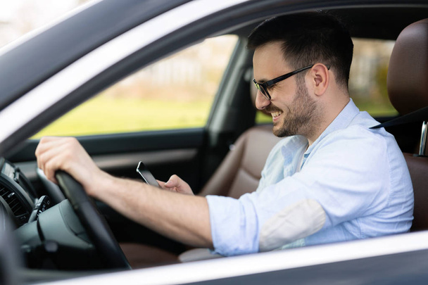 Jóképű üzletember, figyelmen kívül hagyva a biztonsági és textil onmobile telefon vezetés közben - Fotó, kép