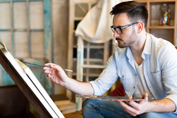 Portrait Of Male Artist Working On Painting Art In Studio - Φωτογραφία, εικόνα