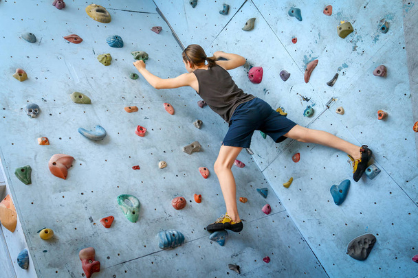Teenage Boy Training Climbing On Indoor Climbing Wall - Photo, Image