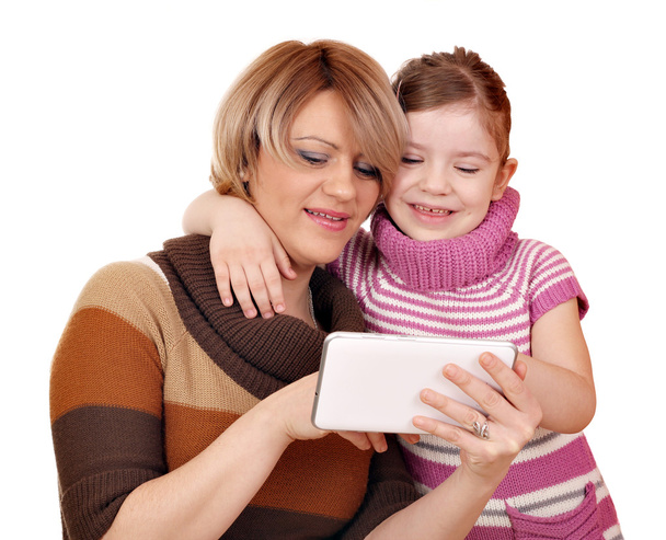 mother and daughter play with tablet pc on white - Zdjęcie, obraz