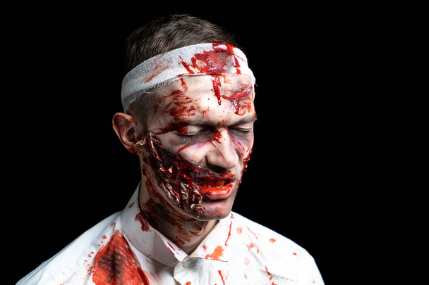 Crazy zombie horror make up. Person in white shirt with bloody sweat. Scars, deep scratches realistic art make-up. head is re-banded bandage, beaten with a stick. Horizontal banner for Halloween party - Foto, imagen