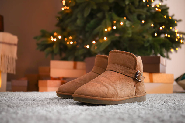 Teplé boty na koberci v obýváku zdobené na Vánoce - Fotografie, Obrázek