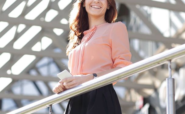 confident business woman standing on the balcony of a modern office building - Photo, image