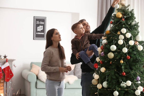 Οικογένεια διακόσμηση όμορφο χριστουγεννιάτικο δέντρο στο δωμάτιο - Φωτογραφία, εικόνα