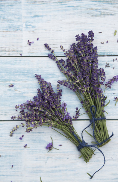bunches of lavender flowers on white wooden table  - Photo, Image