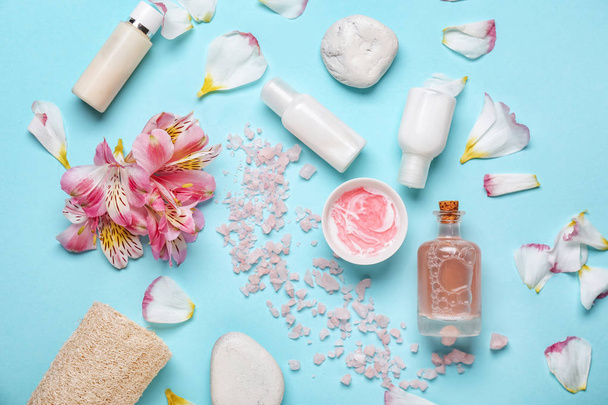 Beautiful spa composition with sea salt and cosmetics on color background - Photo, Image