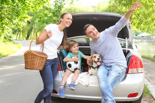 Happy family with cute dog near car outdoors - Foto, Imagem