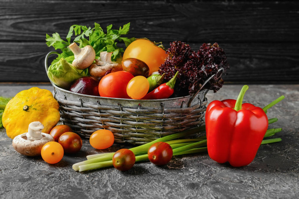 Basket with various fresh vegetables on dark table - Photo, Image