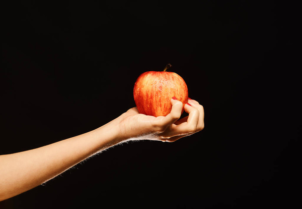 Farming and healthy nutrition concept. Female hand holds fresh fruit - Zdjęcie, obraz