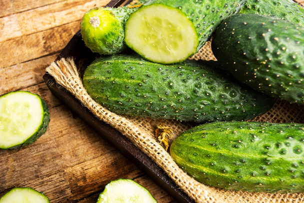 Fresh cucumbers on a rustic cloth top view - Photo, Image