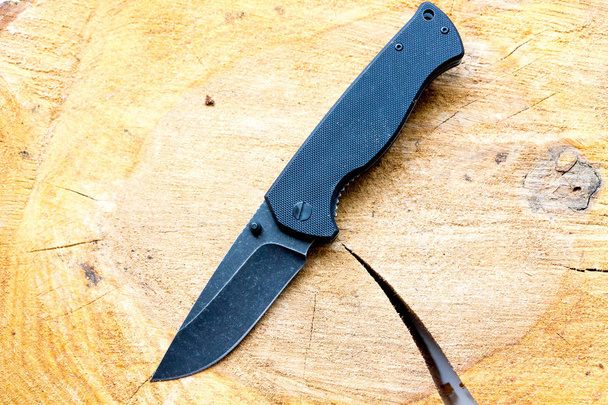 Pocket knife with a black blade. Casual knife. - Photo, Image