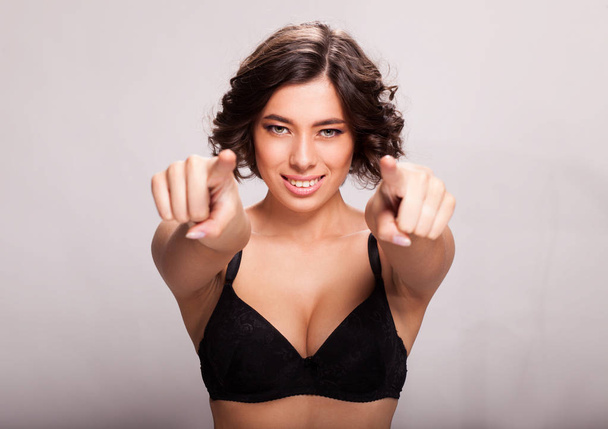 Portrait of beautiful sensual woman posing in black bra on white background - Fotografie, Obrázek