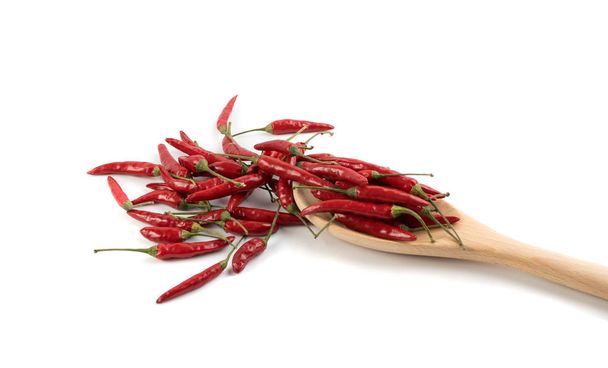 Heap of Small Very Hot Chili Peppers in Wooden Spoon Isolated on White Background. Red Spicy Chilli Pepper Mix for Packaging Advertising, Indian Menu or Oriental Food Design - Photo, Image