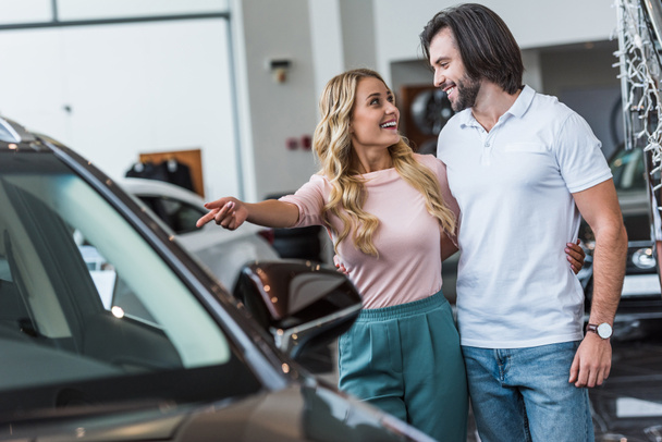 young couple choosing automobile at dealership salon - Foto, immagini