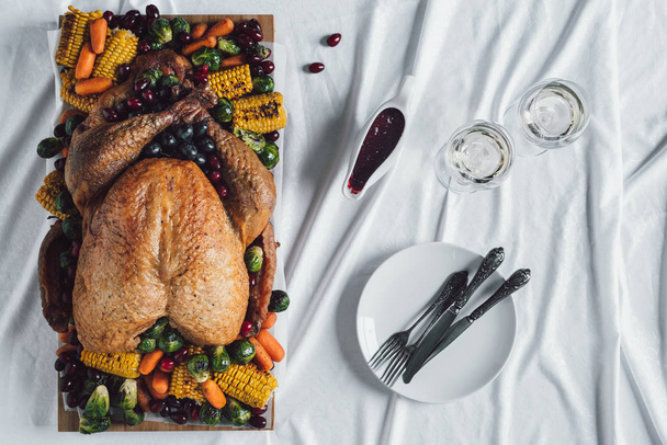 flat lay with roasted turkey, vegetables and glasses of wine for thanksgiving holiday dinner on tabletop - Fotografie, Obrázek