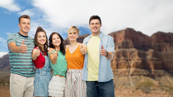 friends showing thumbs up over grand canyon - Photo, Image