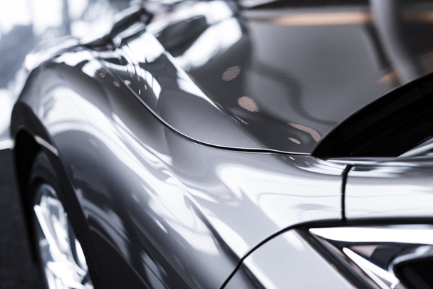 close up view of luxury shiny car in auto salon - Foto, afbeelding