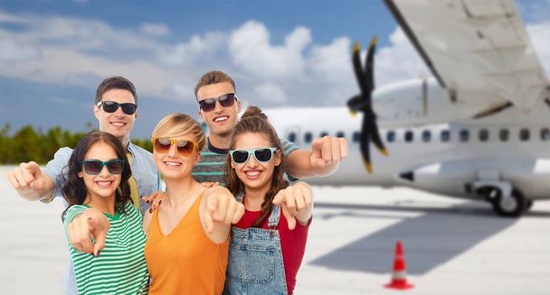 friends pointing at you over plane on airfield - Photo, Image