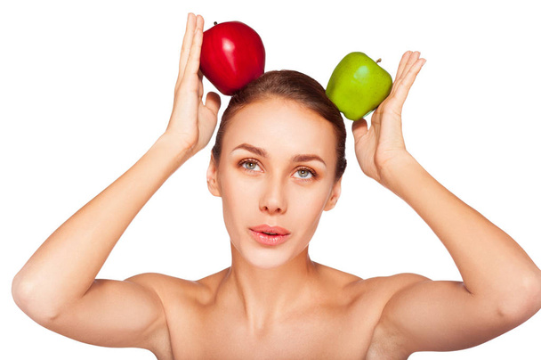 Portrait of young woman with natural makeup posing with green and red apples on white background  - Photo, Image