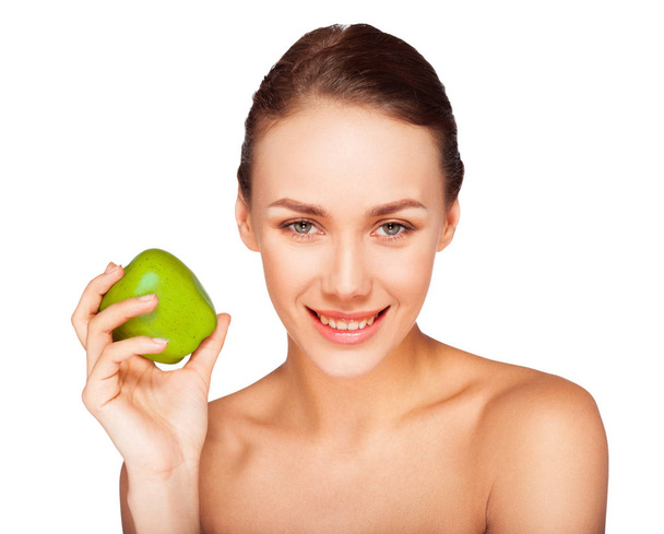 Portrait of young woman with natural makeup posing with green apple on white background  - Fotoğraf, Görsel