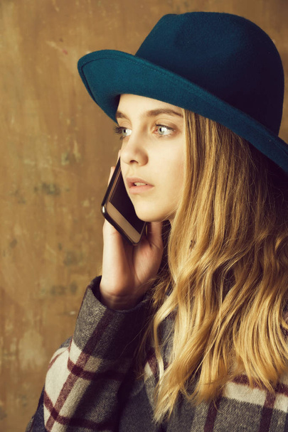 girl in hat with phone - Фото, изображение