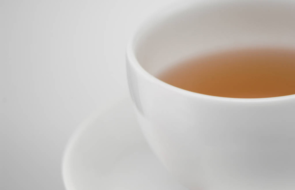 white ceramic cup of tea, macro photography - Foto, afbeelding