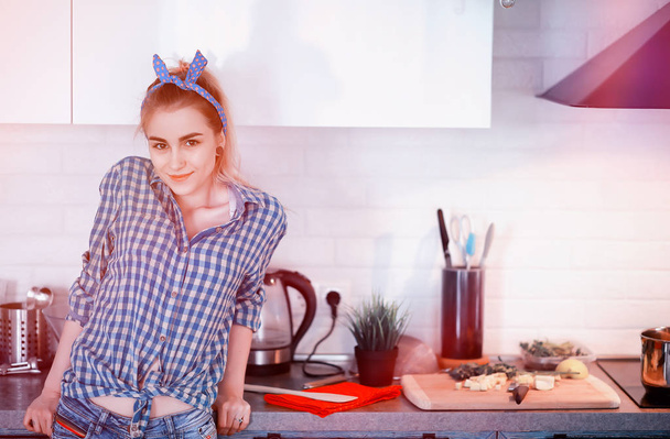 Söpö nuori tyttö keittiössä valmistaa ruokaa
 - Valokuva, kuva