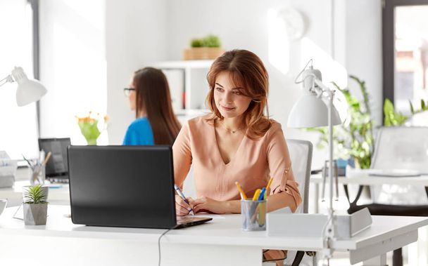 businesswoman with laptop working at office - Fotó, kép