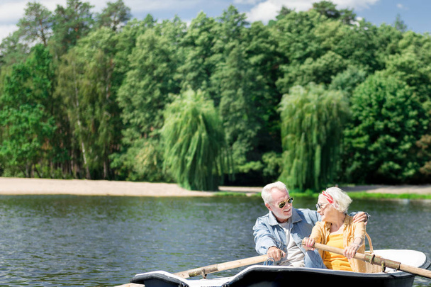 Senior couple hugging while enjoying the nature and boating - Photo, Image