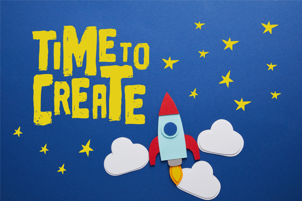 clouds and rocket on blue background with "time to create" inspiration   - Foto, Bild