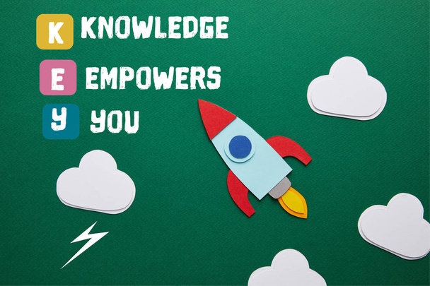 top view of rocket and clouds on green chalkboard with "KEY - knowledge empowers you" inspiration - Photo, Image