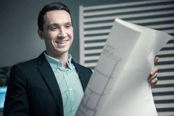 Cheerful leader approving professional drawings of his employee - Fotoğraf, Görsel