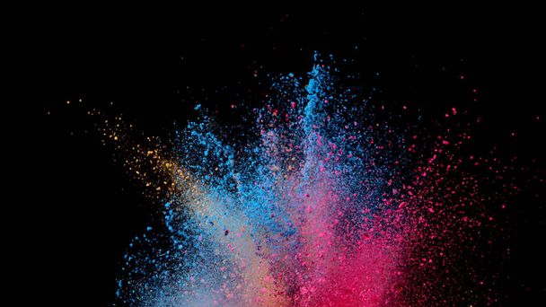 Explosion of coloured powder isolated on black background. Abstract colored background - Foto, immagini