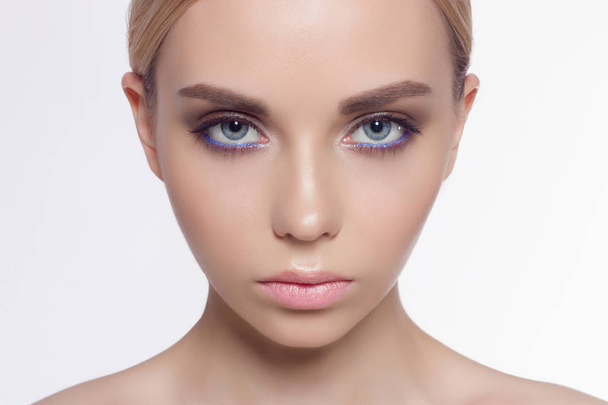 The beautiful young blonde with blue eyes, gentle care. Fashionable cosmetics in eyes, full lips and magnificent eyebrows. Correction of eyebrows, face a thin skin, cosmetology, cosmetics, Spa - Photo, Image