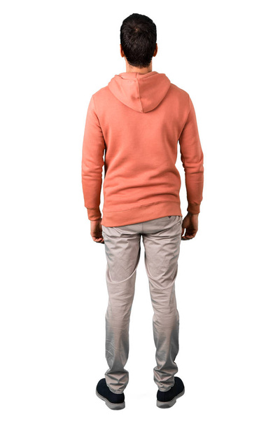 Full body of Man in a pink sweatshirt looking back on isolated white background. Ideal for use in architectural designs - Foto, immagini