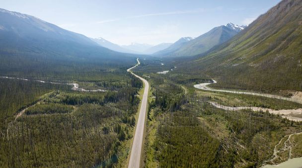 Aerial panoramic landscape view of a scenic road in the Canadian Rockies during a vibrant sunny summer day. Taken in Banff Windermere Parkway, Alberta, Canada. - 写真・画像