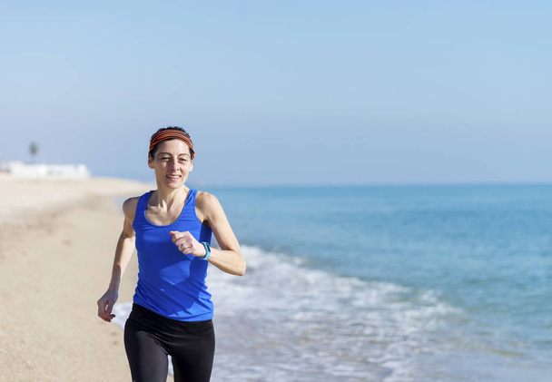 Woman Exercising On Beach ( running ) - Фото, зображення