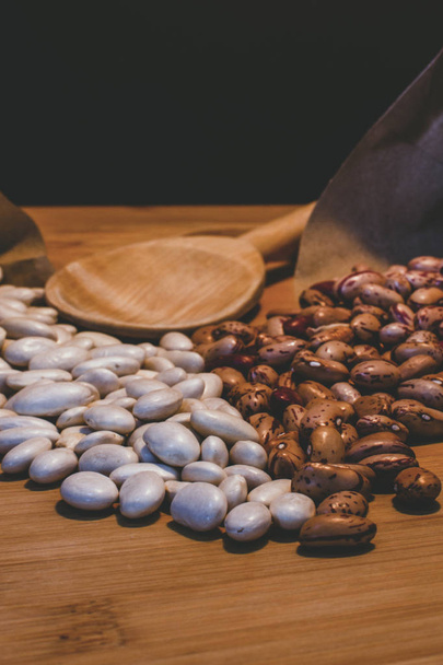 white beans and raw pints on wooden background. healthy food. vegetable. Vegan, vegetarian cuisine. Beans - Photo, Image